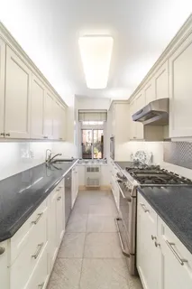 a large kitchen with stainless steel appliances granite countertop a stove a sink and a granite counter tops