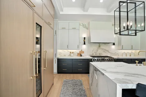 a kitchen with stainless steel appliances a stove a sink and a microwave