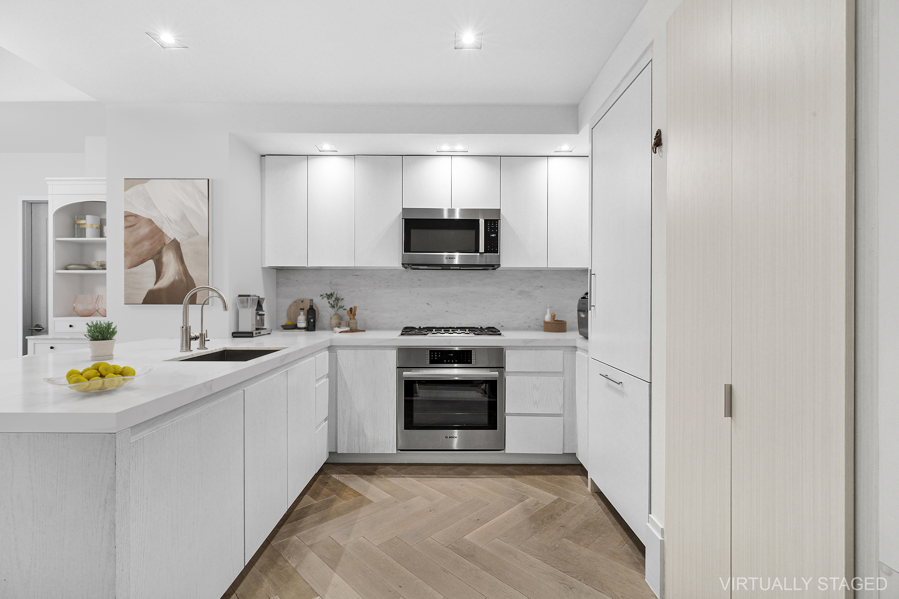 101 Wall Street, Unit 17A Manhattan, NY 10005 - Photo 4 of 13 a kitchen with a refrigerator and a stove top oven