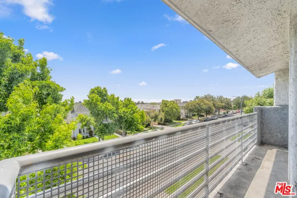 a view of a balcony with wooden fence