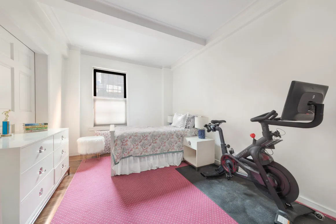 a bedroom with furniture and a wooden floor