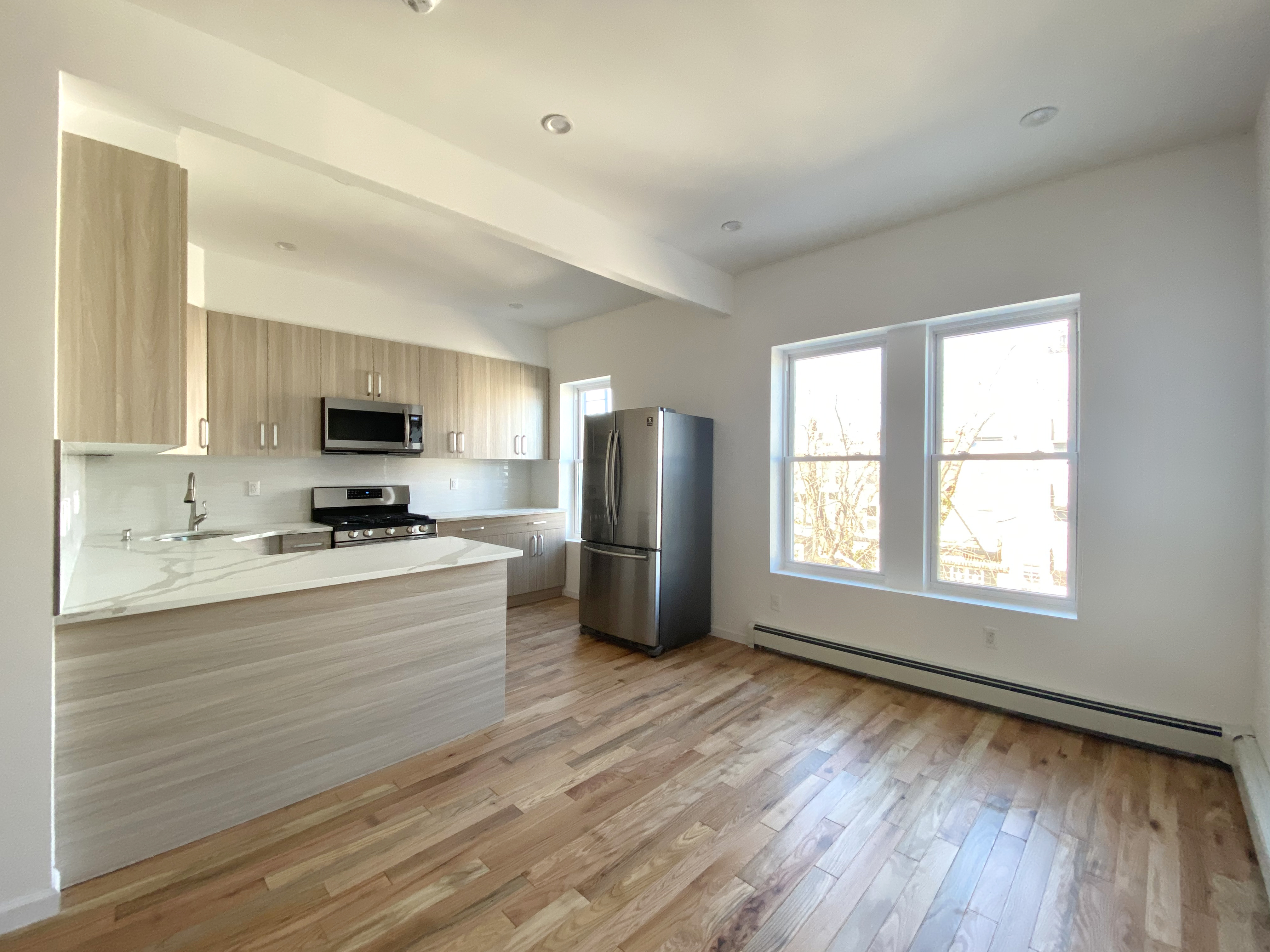 175 Luquer Street, Unit 4 Brooklyn, NY 11231 - Photo 12 of 21 a kitchen with granite countertop a refrigerator stove top oven and sink