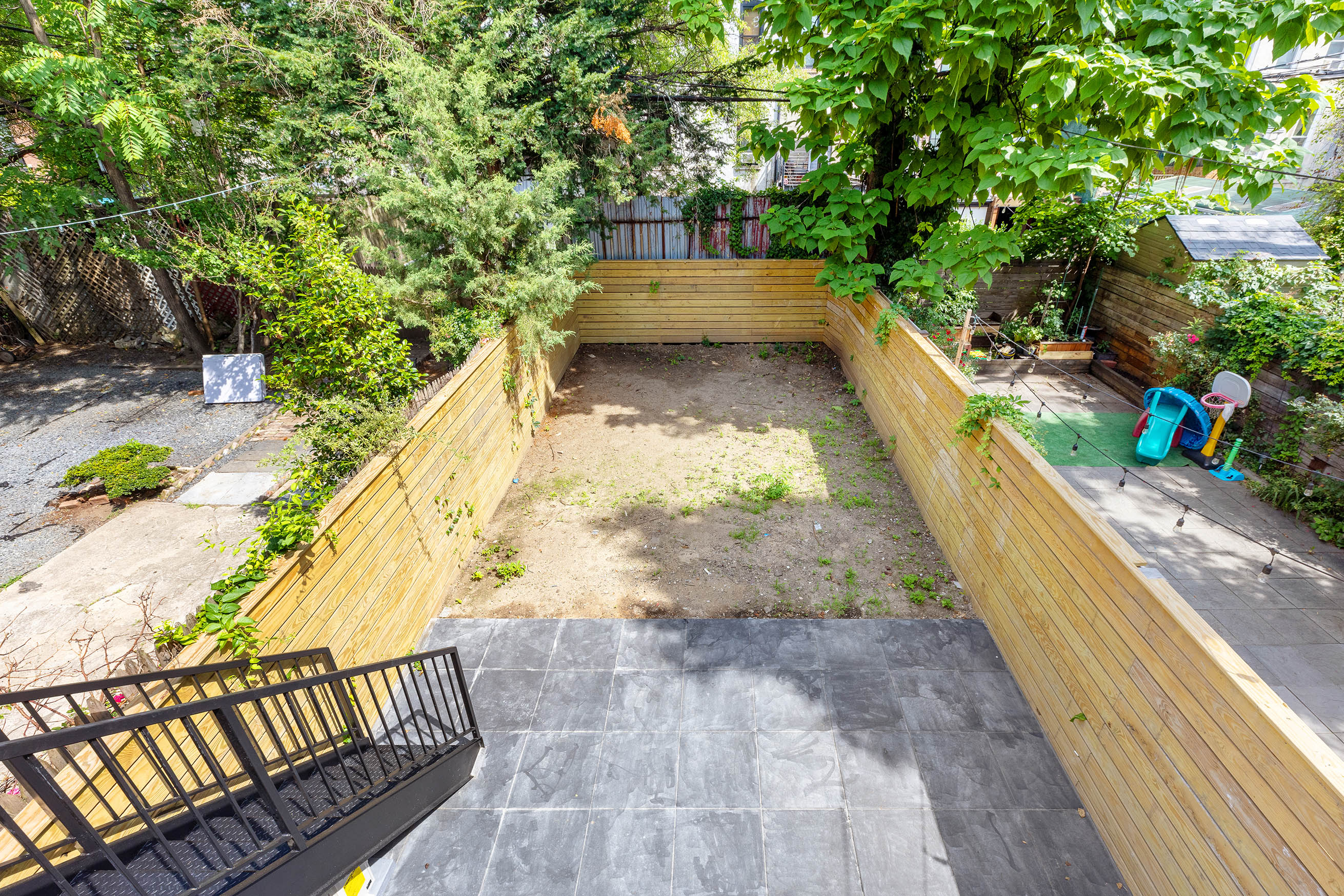 647 Macon Street Brooklyn, NY 11233 - Photo 17 of 20 a view of a yard with large trees
