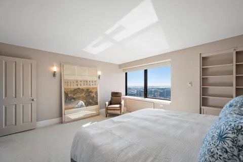 a bedroom with a large bed and a large window