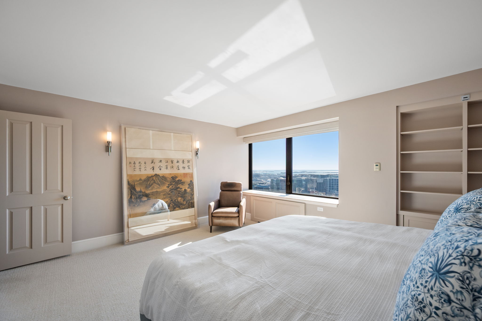 65 East India Row, Unit 38 F/G Boston, MA 02110 - Photo 16 of 32 a bedroom with a large bed and a large window