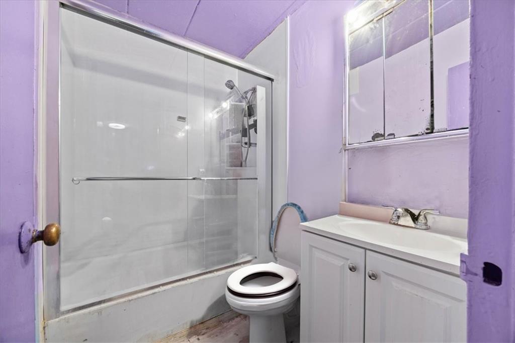 1431 East 108th Street, Unit 10E Brooklyn, NY 11236 - Photo 5 of 10 a bathroom with a sink a toilet and shower