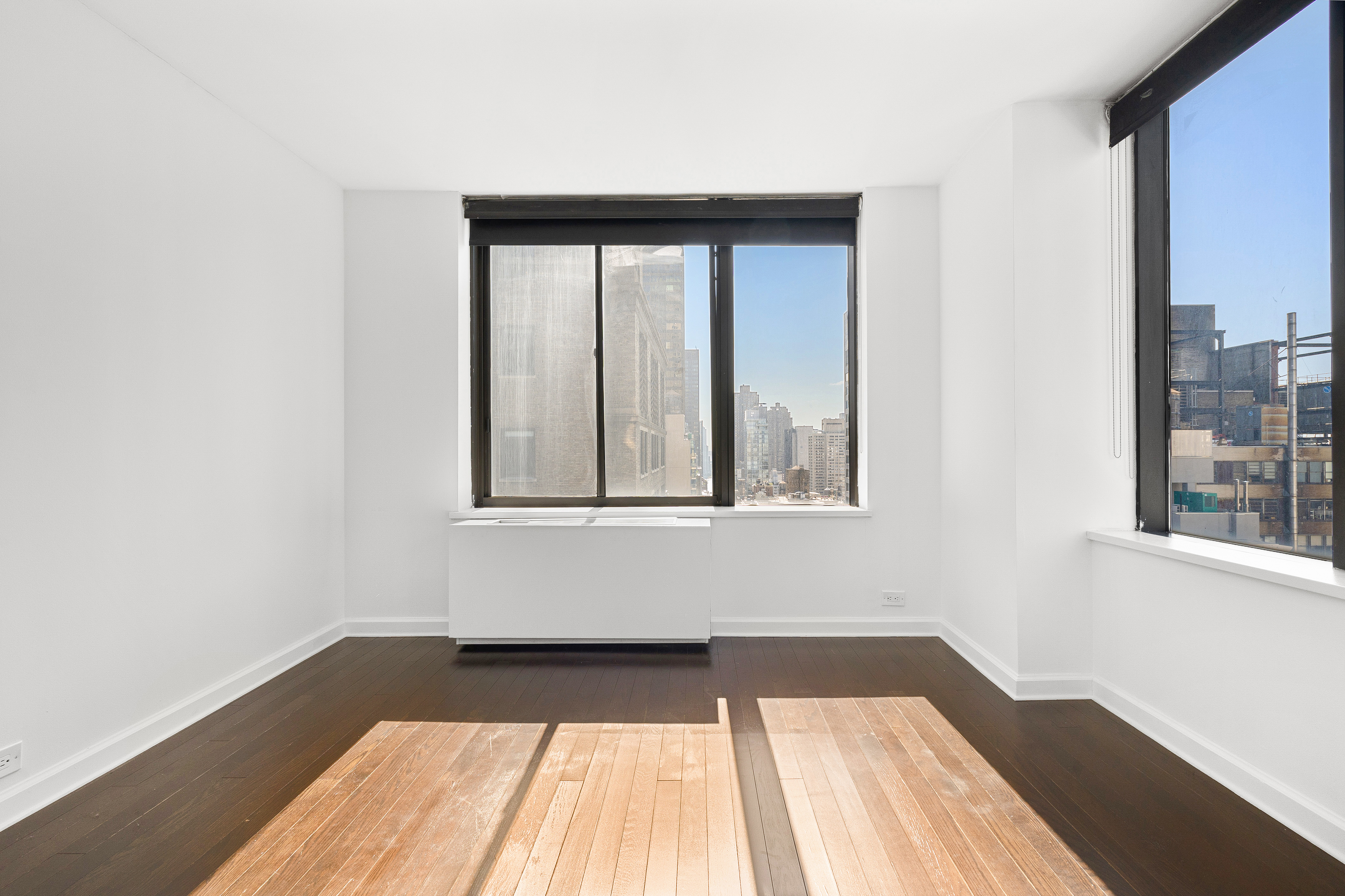 445 5th Avenue, Unit 26F Manhattan, NY 10016 - Photo 6 of 11 a view of a room that has wooden floor and a window