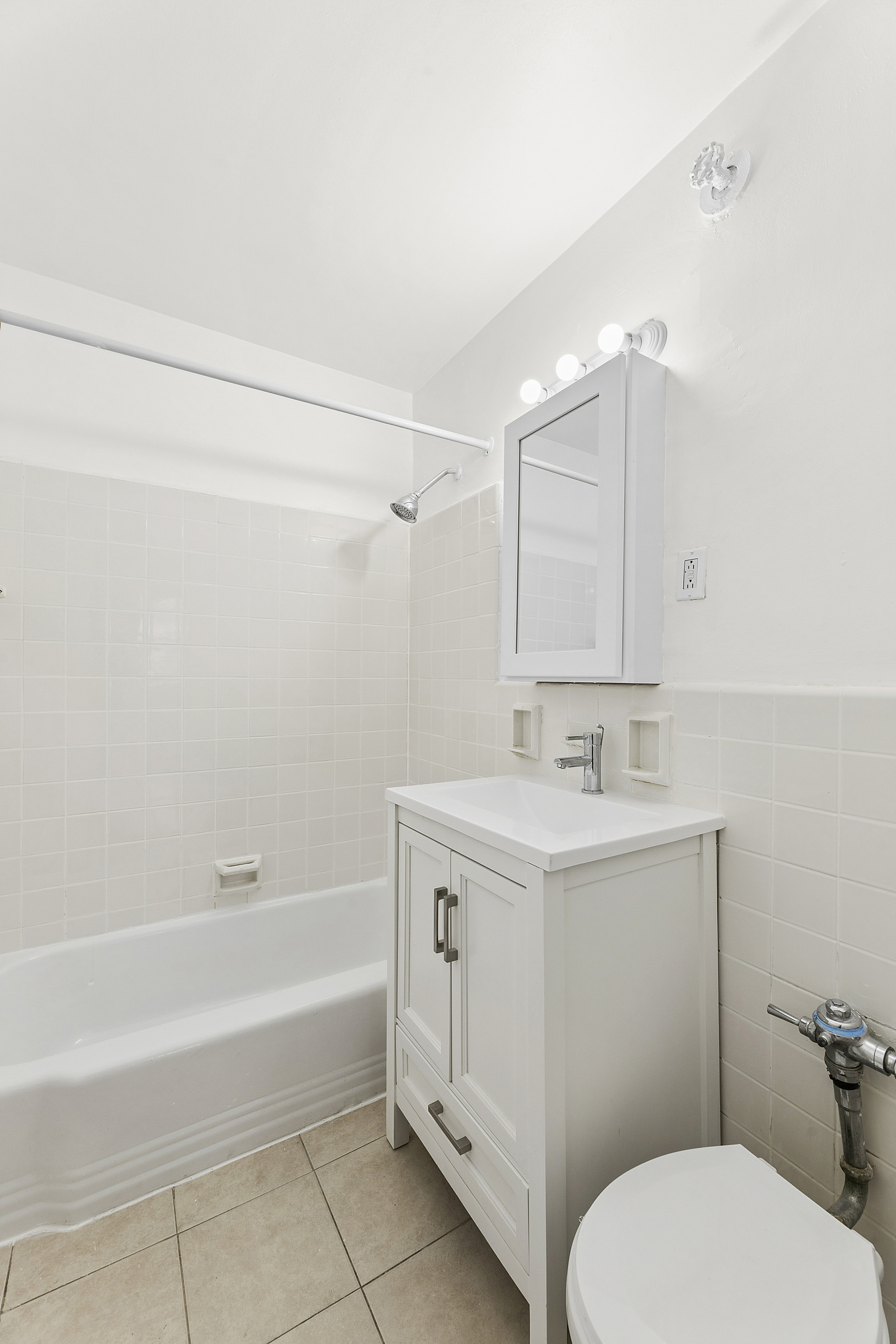 6645 Broadway, Unit 7E Bronx, NY 10471 - Photo 8 of 11 a bathroom with a sink a toilet and shower