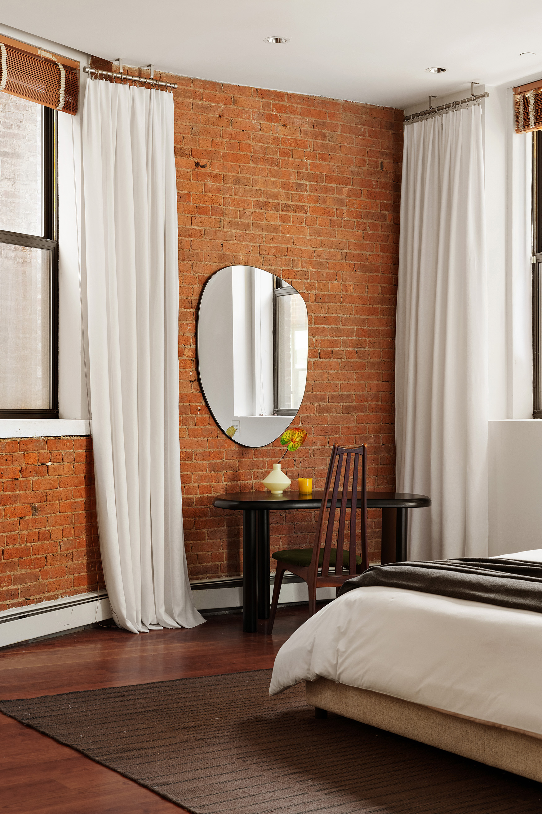 40 West 13th Street, Unit 2 Manhattan, NY 10011 - Photo 7 of 14 a bedroom with a bed a mirror and a large window