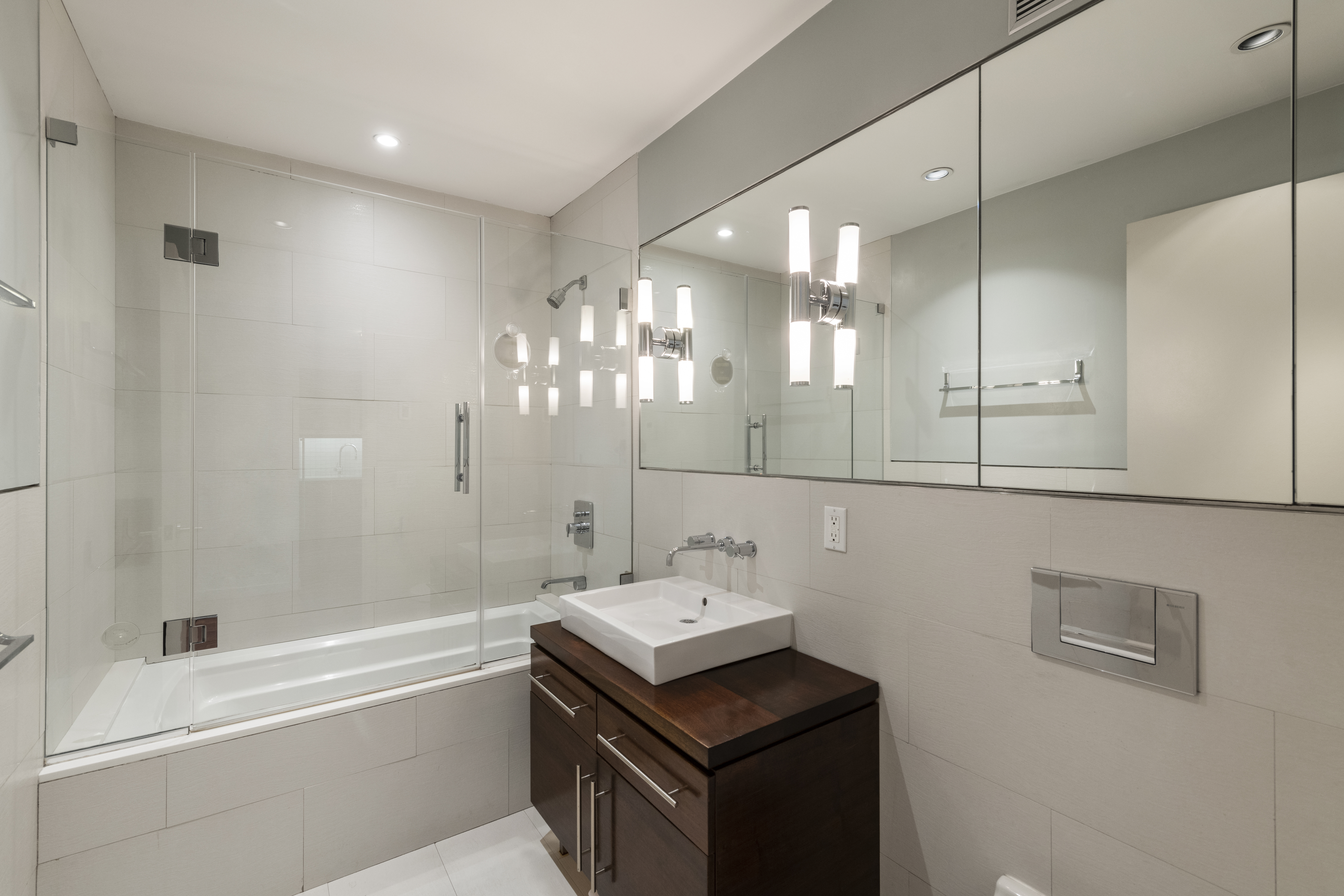 185 13th Street, Unit 2B Brooklyn, NY 11215 - Photo 6 of 8 a bathroom with a sink a large mirror and shower
