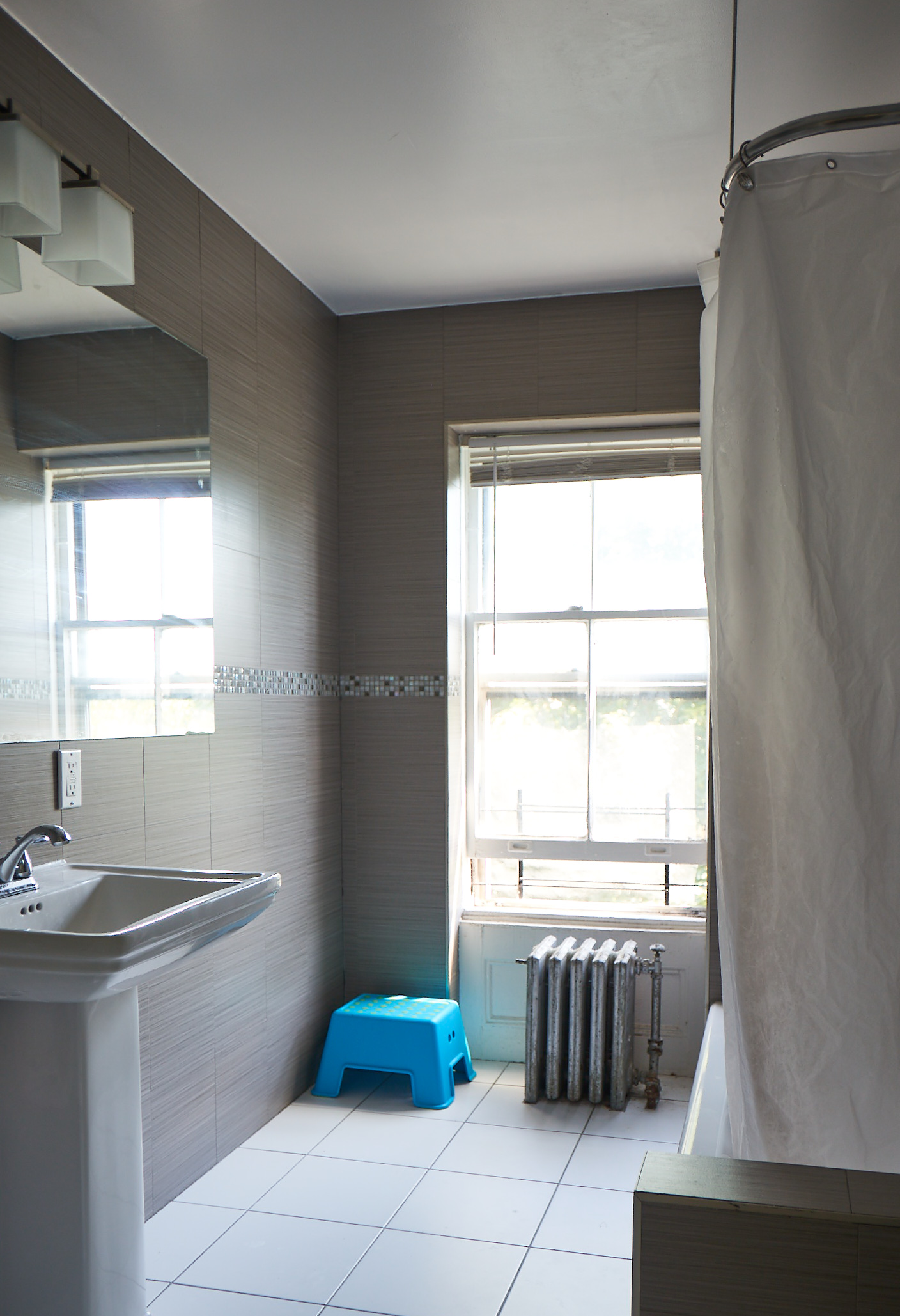 660 Macon Street Brooklyn, NY 11233 - Photo 11 of 17 a bathroom with a tub and a sink
