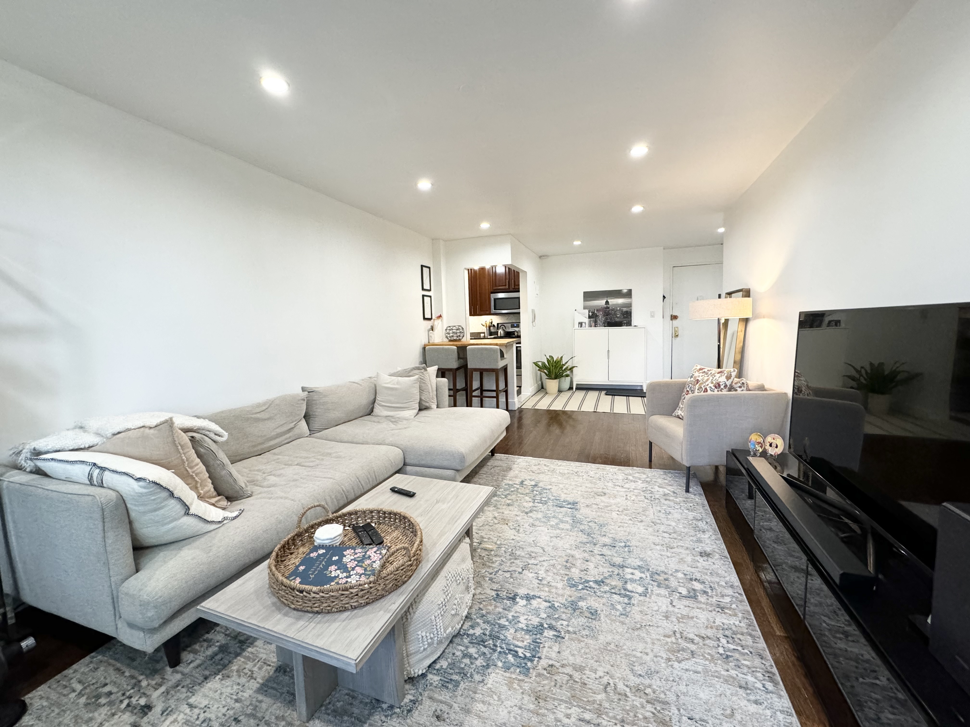 310 Lenox Road, Unit 4D Brooklyn, NY 11226 - Photo 3 of 14 a living room with furniture and a flat screen tv