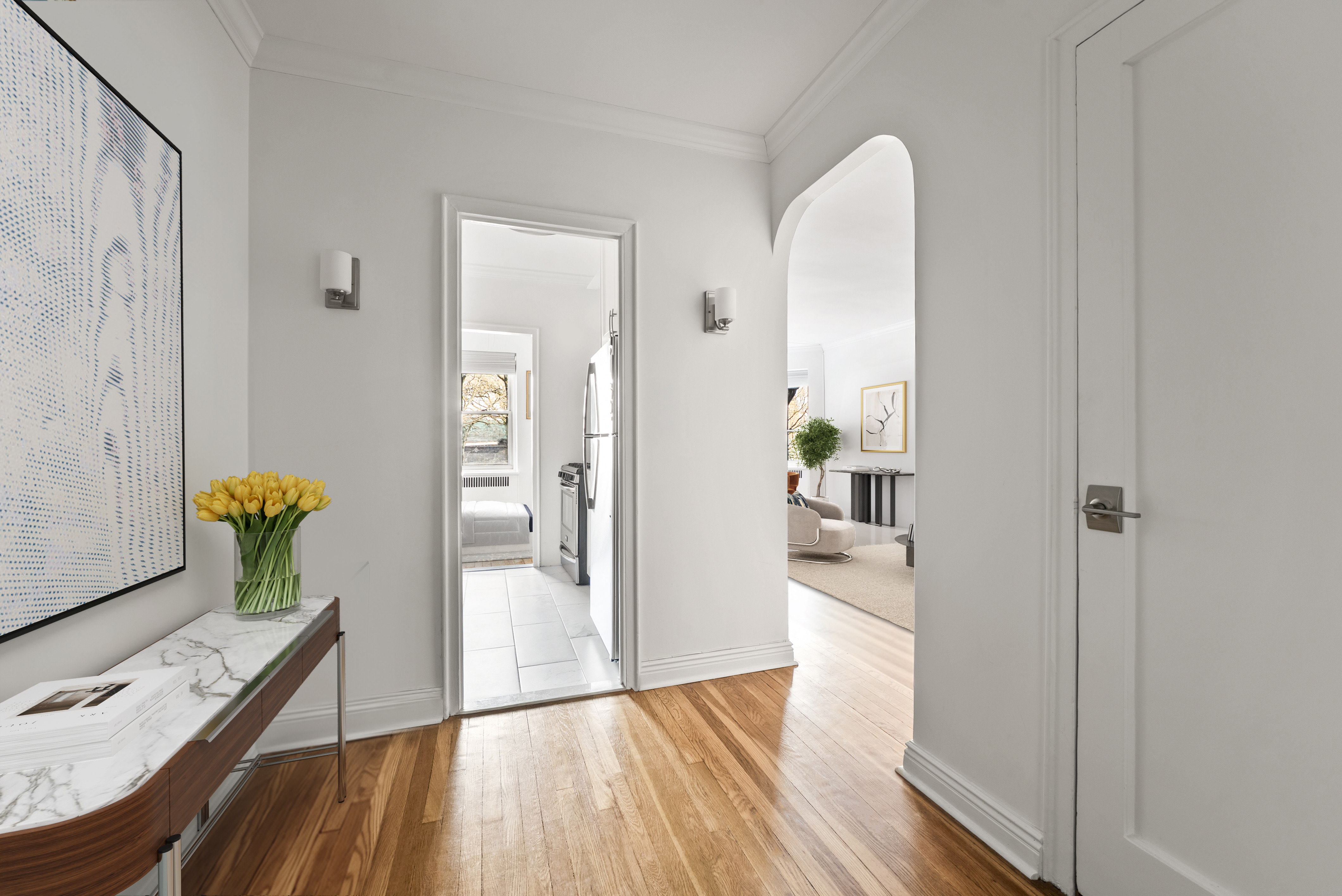 530 East 90th Street, Unit 2M Manhattan, NY 10128 - Photo 6 of 12 a view of a hallway to a livingroom and a dining room with furniture