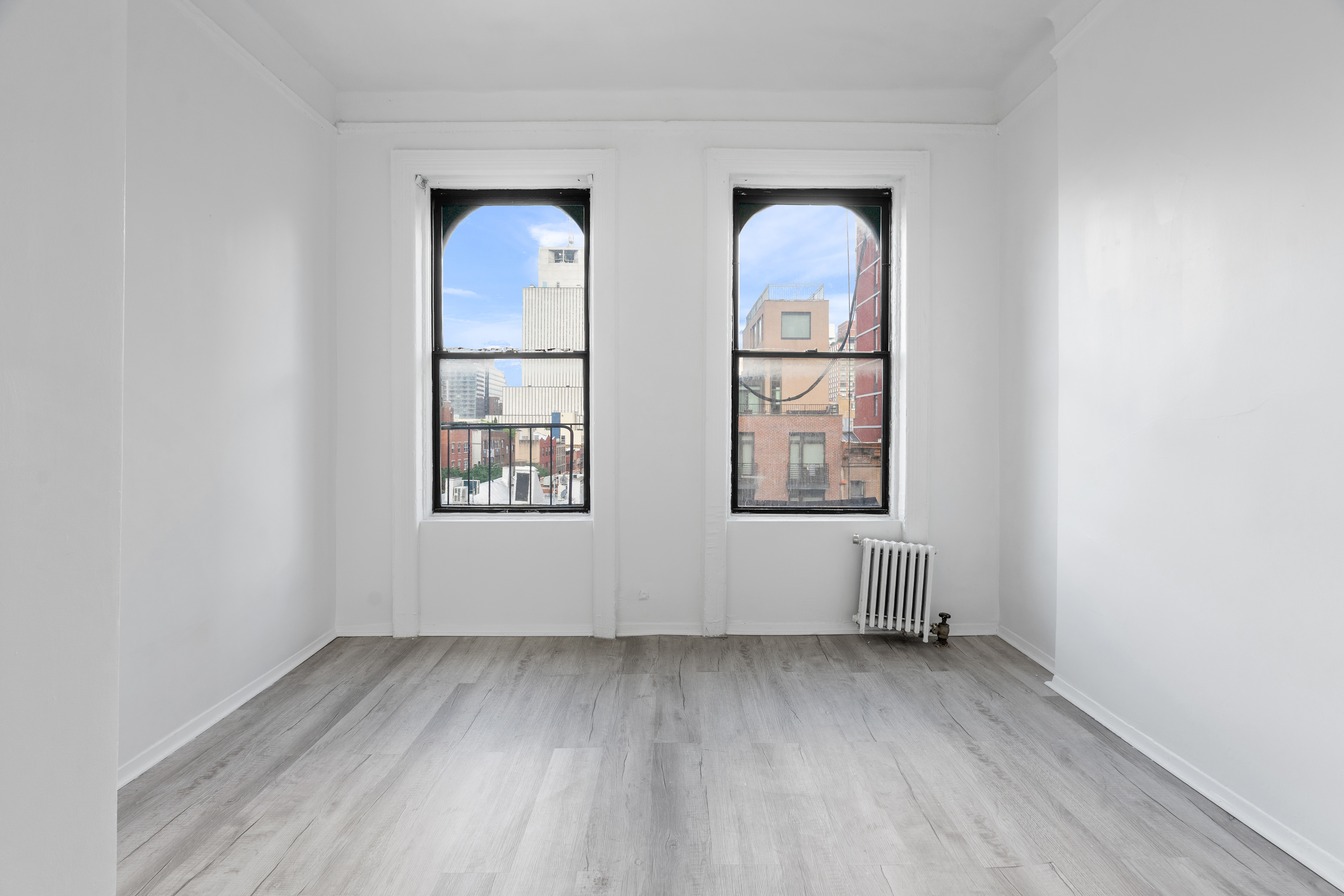 824 9th Avenue, Unit 5RN Manhattan, NY 10019 - Photo 2 of 11 an empty room with windows