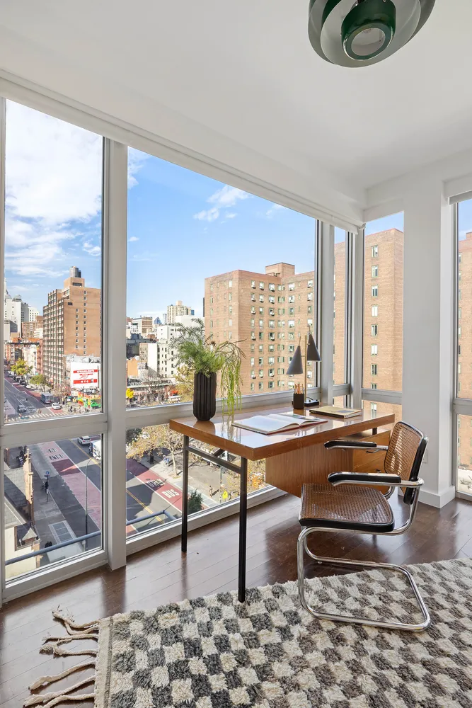 a living room with furniture and a floor to ceiling window