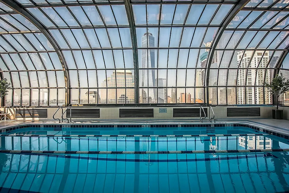 200 Rector Place, Unit 37J Manhattan, NY 10280 - Photo 6 of 12 a view of an empty room with wooden floor