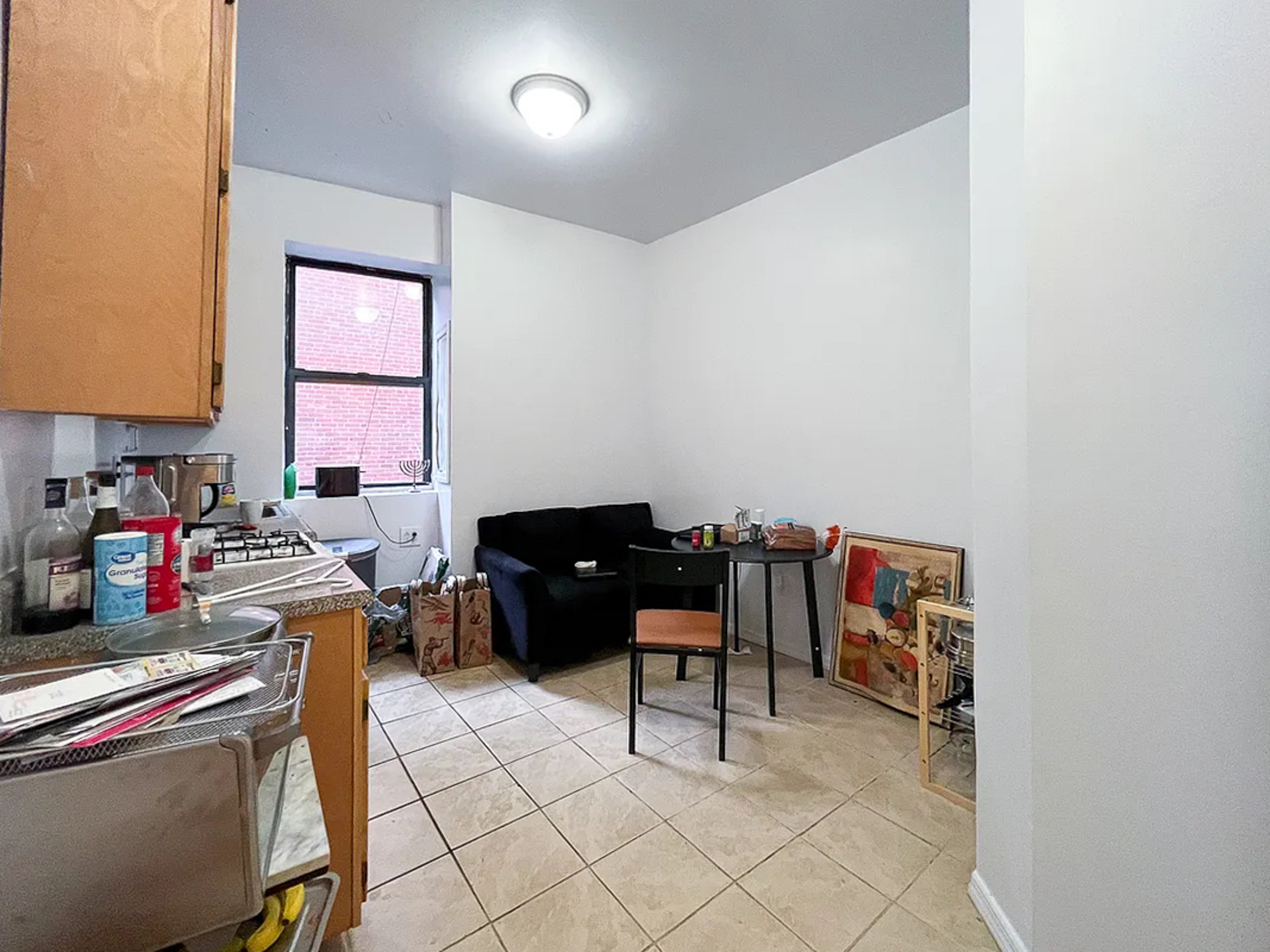55 East 2nd Street, Unit 7 Manhattan, NY 10003 - Photo 5 of 18 a work room with furniture a rug and a window