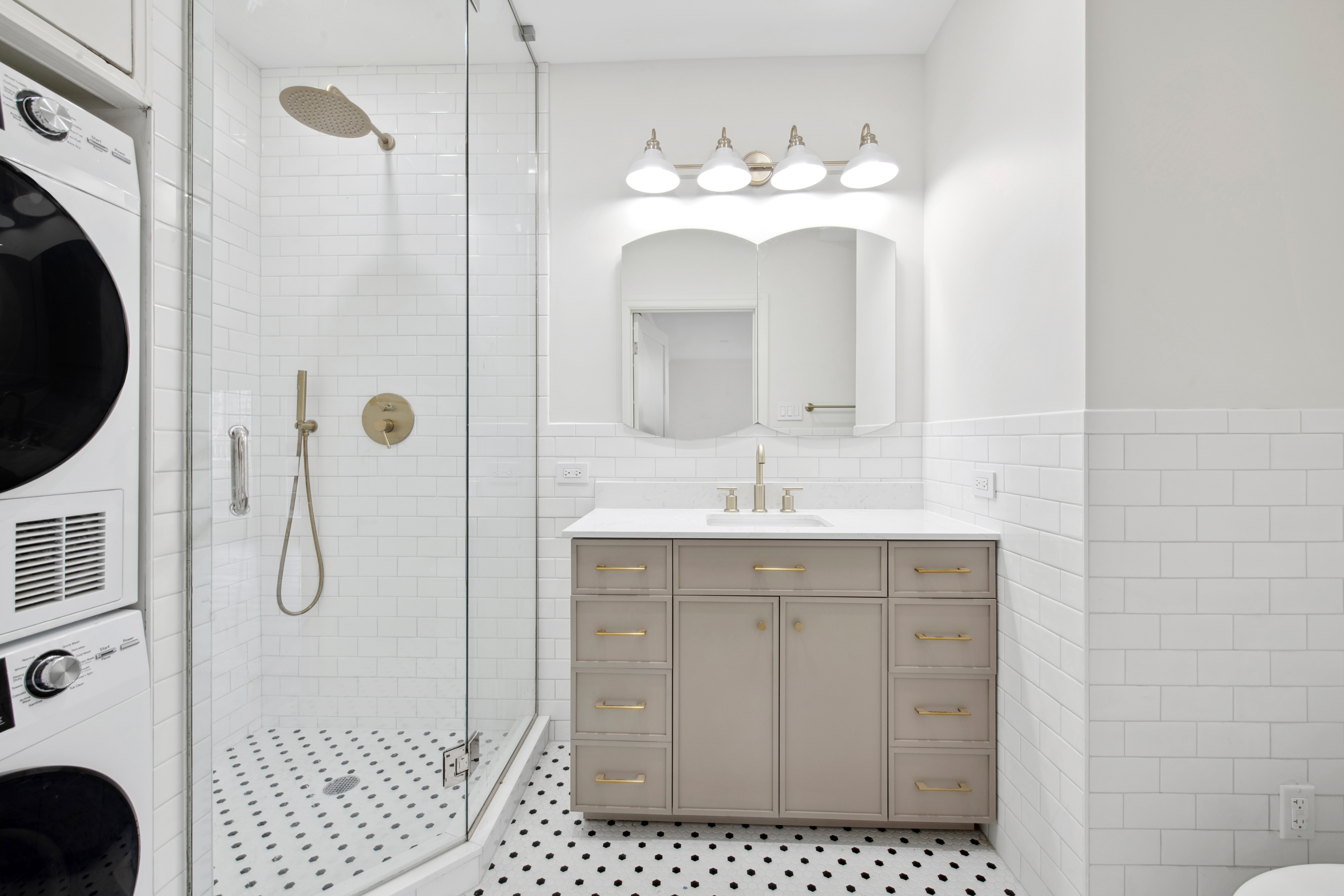 212 East 70th Street, Unit 4B Manhattan, NY 10021 - Photo 12 of 16 a bathroom with a shower a sink and a mirror