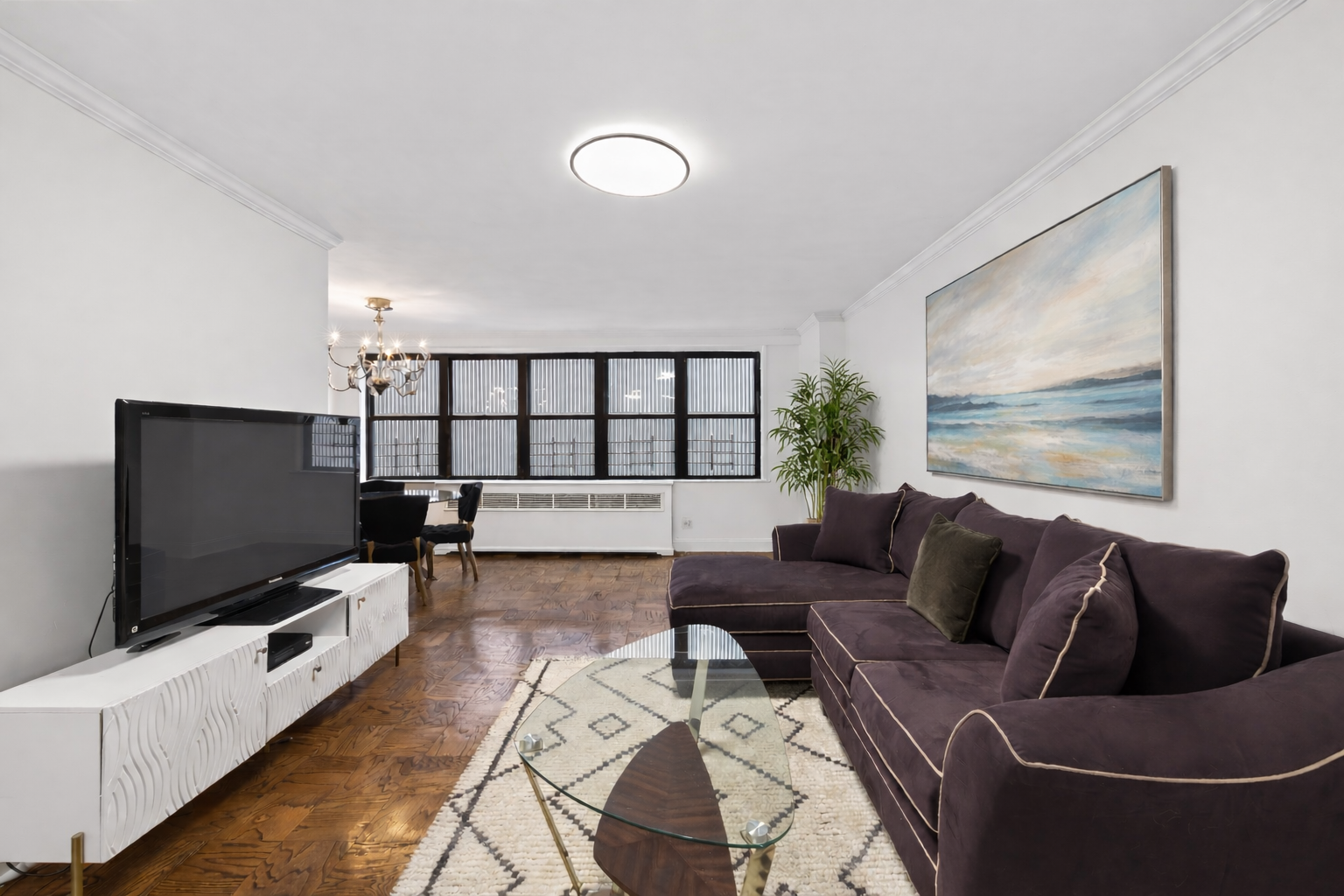 330 3rd Avenue, Unit 8A Manhattan, NY 10010 - Photo 2 of 13 a living room with furniture and a flat screen tv