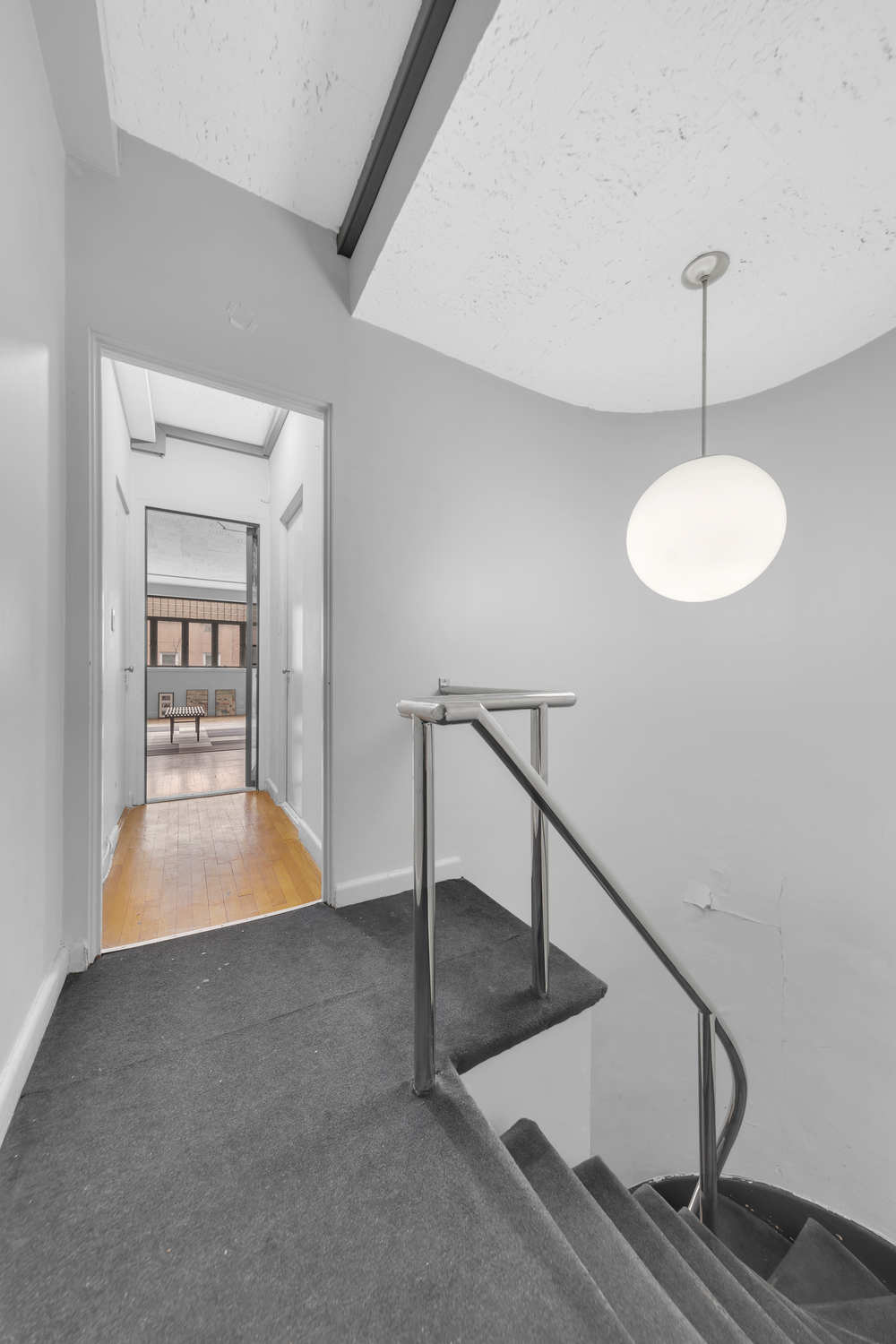 219 East 49th Street Manhattan, NY 10017 - Photo 7 of 19 a view of staircase and kitchen with a sink