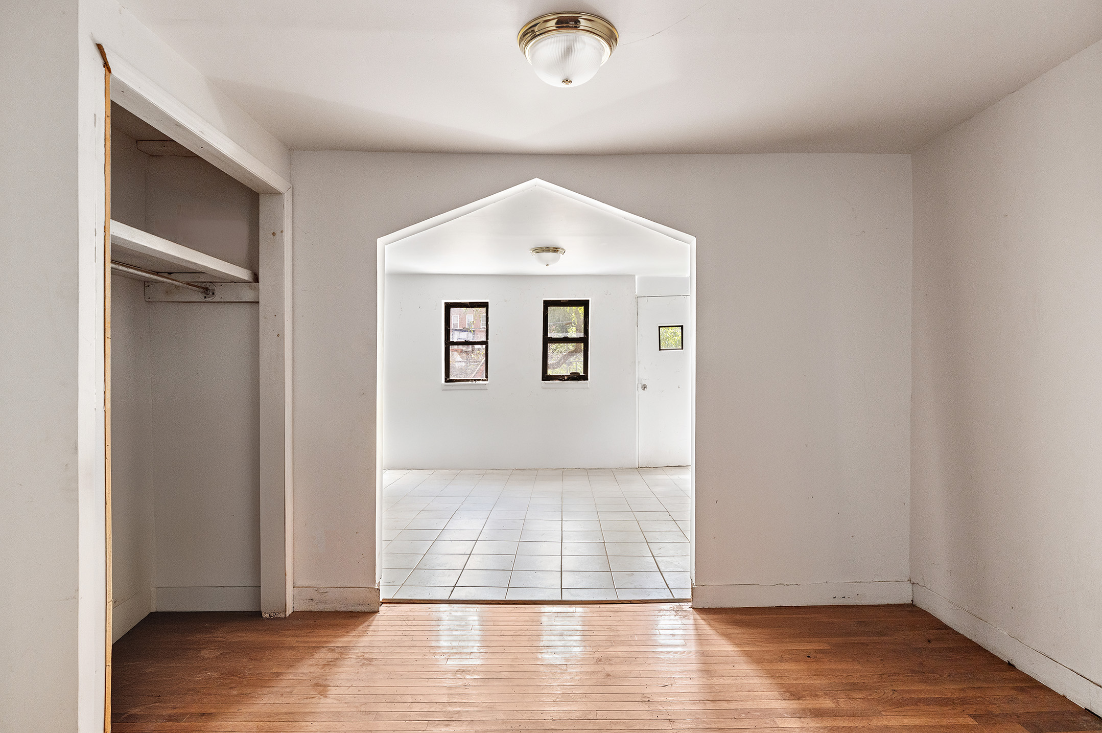 738 Lafayette Avenue Brooklyn, NY 11221 - Photo 5 of 12 an empty room with wooden floor and windows