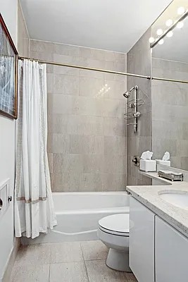 222 Riverside Drive, Unit 5D Manhattan, NY 10025 - Photo 4 of 8 a bathroom with a granite countertop bathtub shower sink vanity and toilet