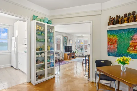a living room with furniture and painting on the wall