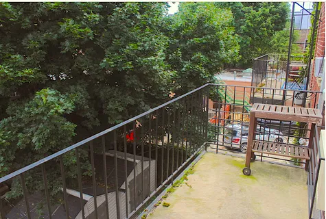 a view of street with couple of cars parked in front of a house