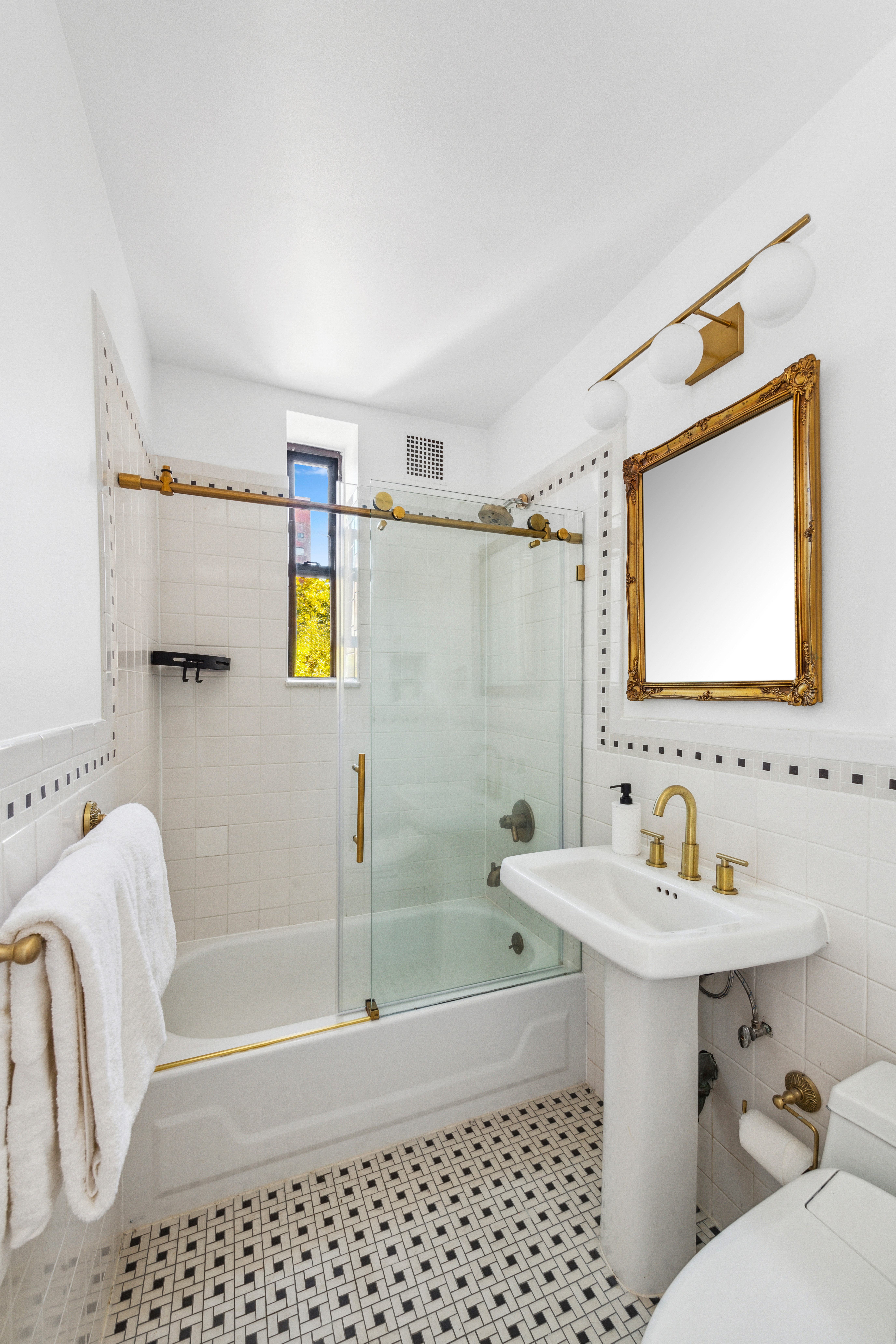210 West 21st Street, Unit 6RE Manhattan, NY 10011 - Photo 8 of 13 a bathroom with a sink toilet and shower
