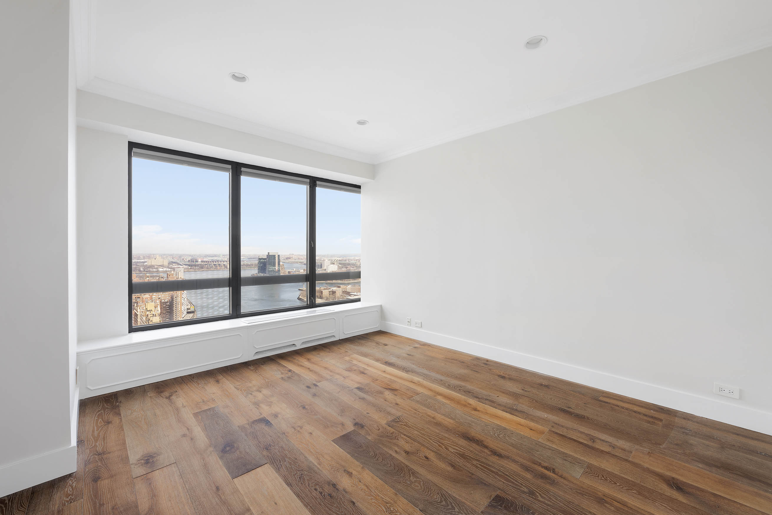 530 East 76th Street, Unit PH36/37E Manhattan, NY 10021 - Photo 17 of 29 an empty room with wooden floor and windows