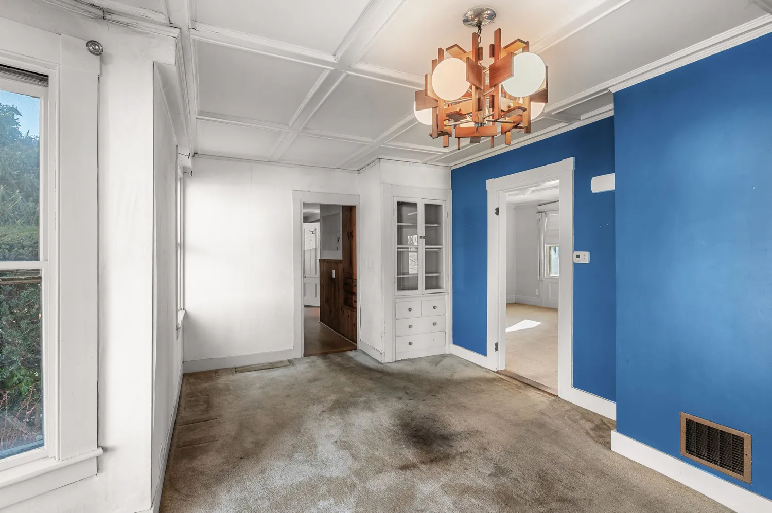 a view of an empty room with a window and closet