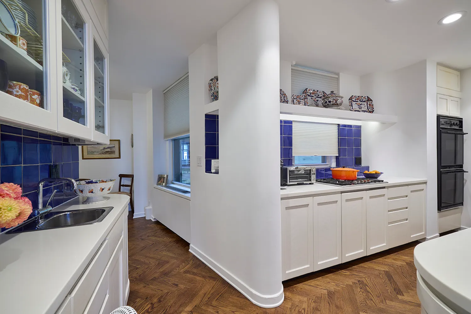 a kitchen with granite countertop a sink stove and cabinets