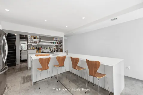 a view of kitchen with windows and refrigerator