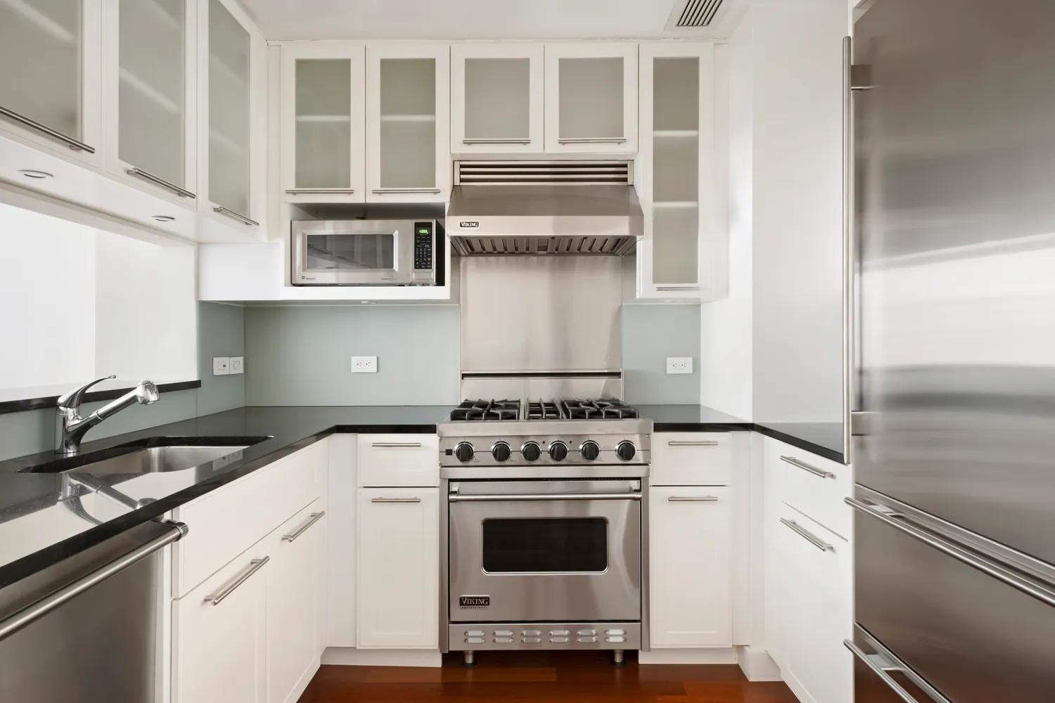 a kitchen with cabinets and appliances