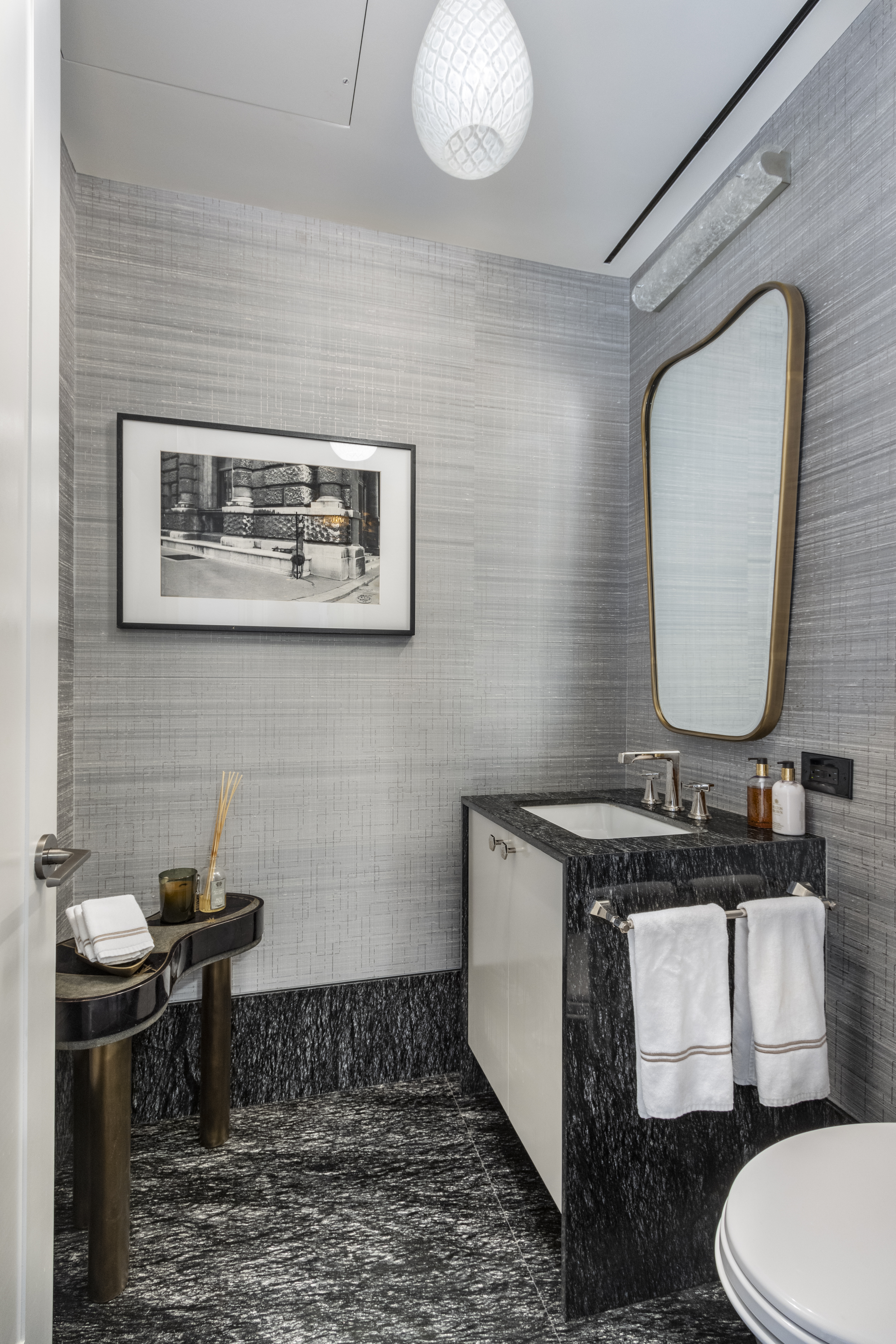 40 East 61st Street, Unit 18A Manhattan, NY 10065 - Photo 6 of 15 a bathroom with a toilet a sink and mirror
