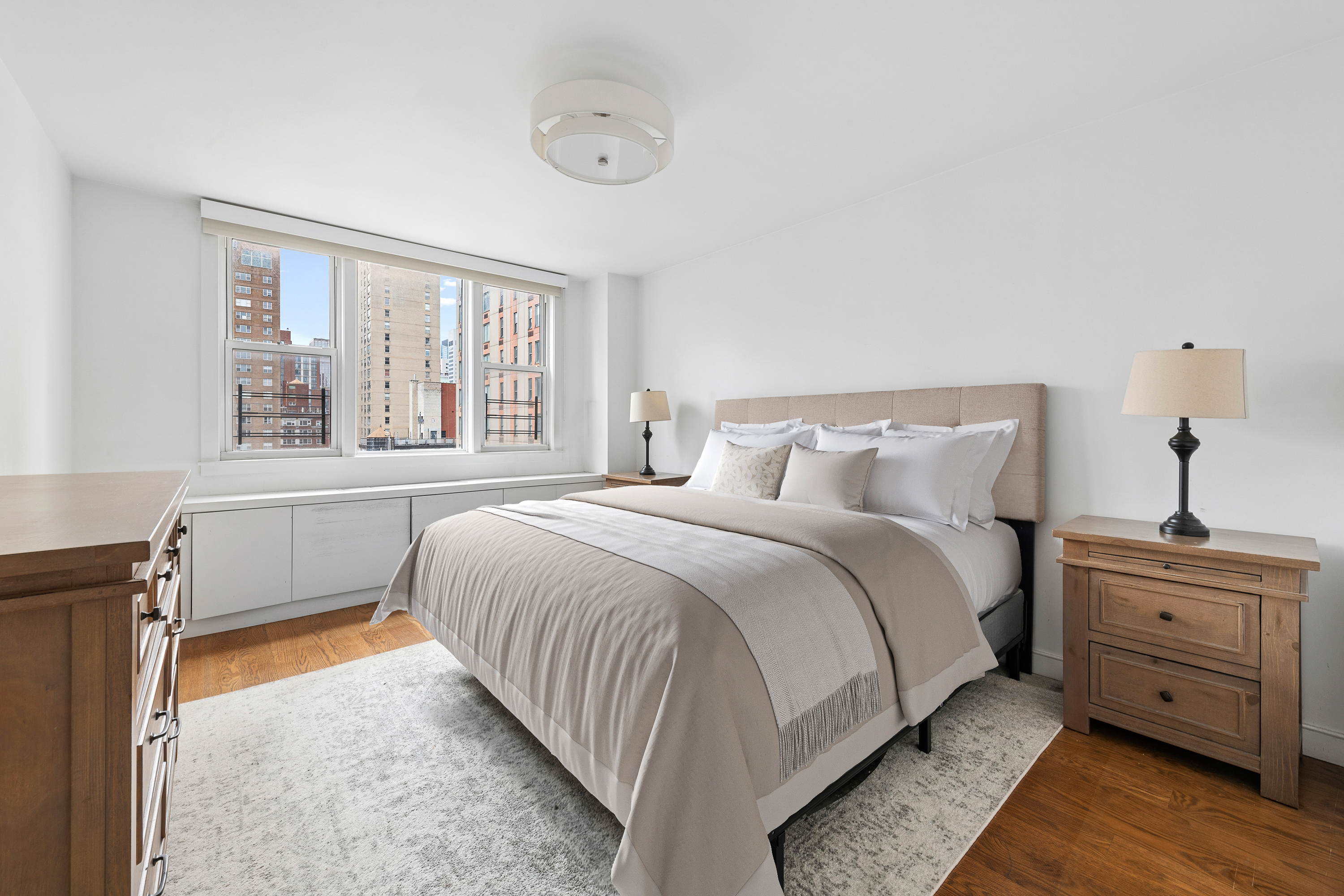 201 East 36th Street, Unit 17C Manhattan, NY 10016 - Photo 7 of 13 a bedroom with a bed and a window
