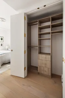 a view of walk in closet with empty racks