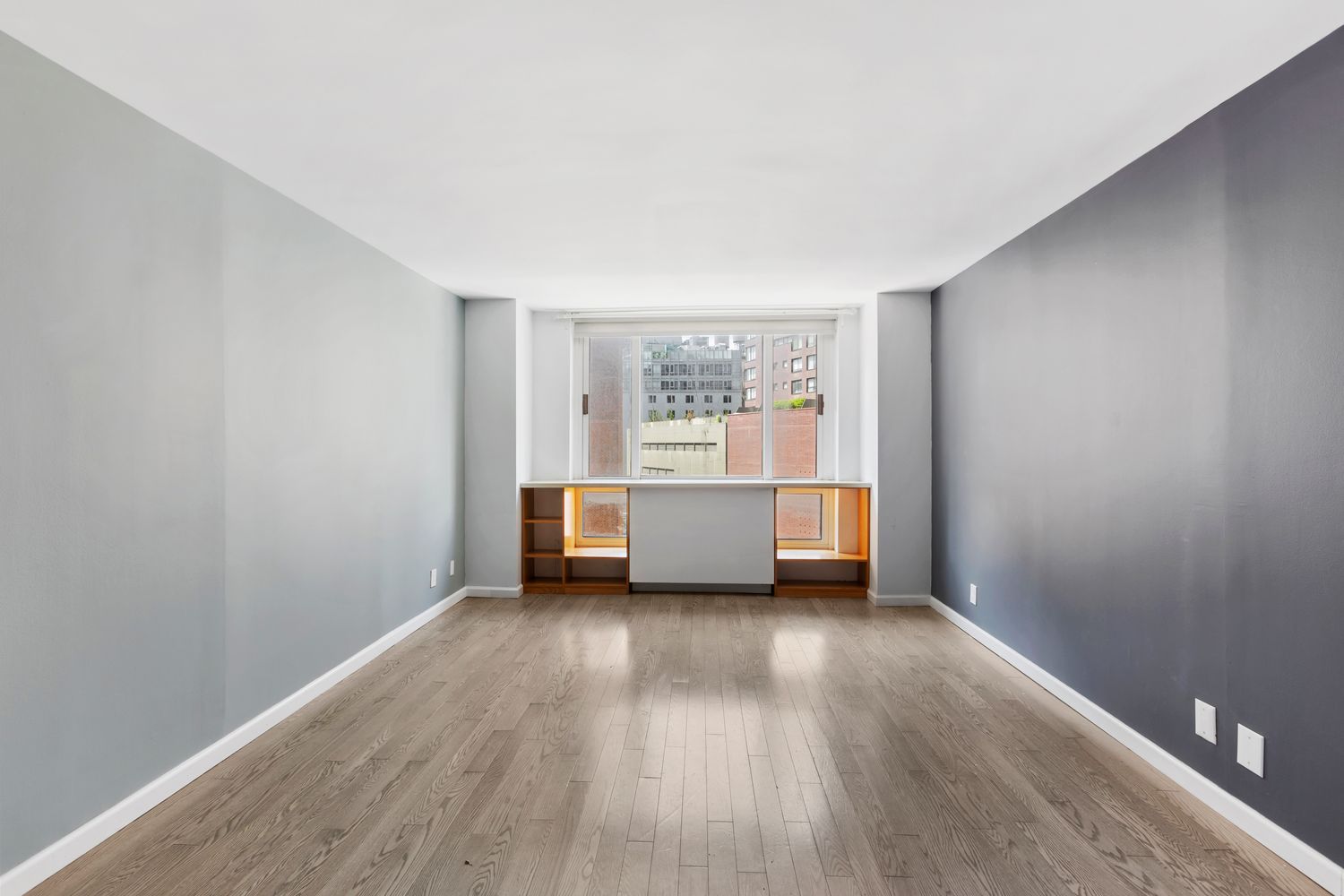 1 Irving Place, Unit U7BC Manhattan, NY 10003 - Photo 10 of 20 a view of an empty room with a window and wooden floor