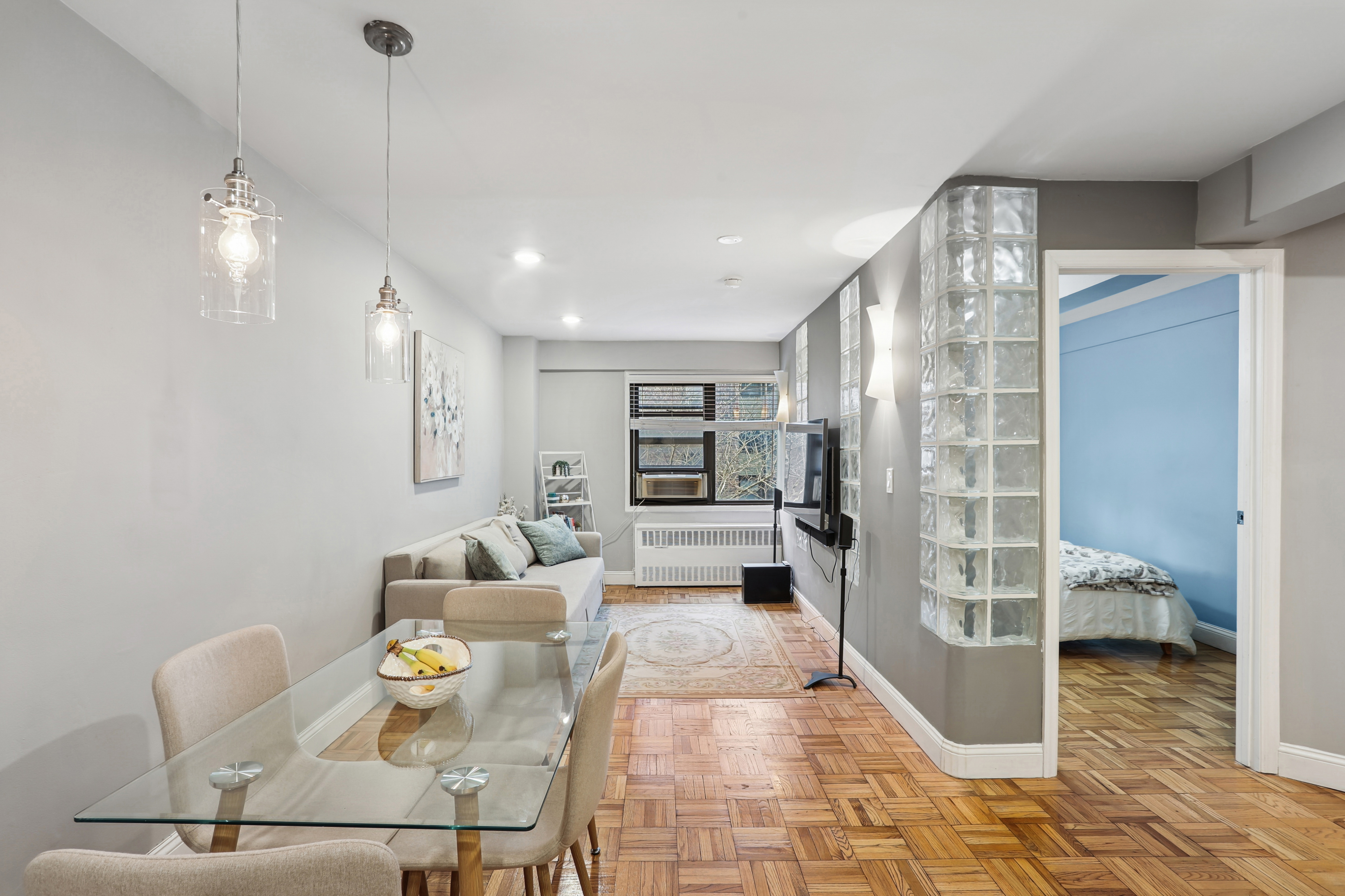 335 East 51st Street, Unit 4H Manhattan, NY 10022 - Photo 3 of 13 a living room with furniture and a chandelier