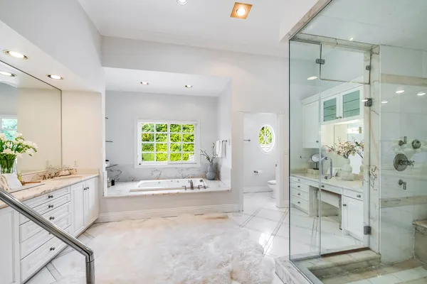 a spacious bathroom with a tub and shower
