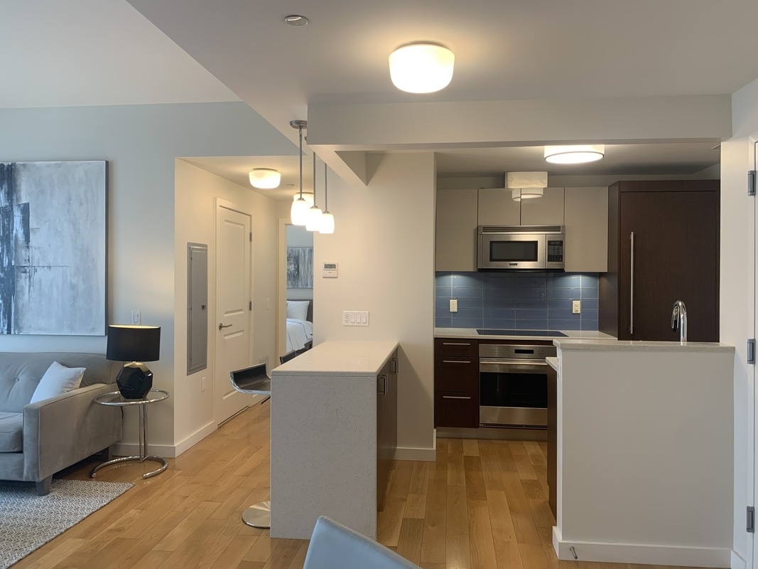 548 4th Avenue, Unit 4B Brooklyn, NY 11215 - Photo 13 of 22 a large kitchen with stainless steel appliances wooden cabinets and a counter top space