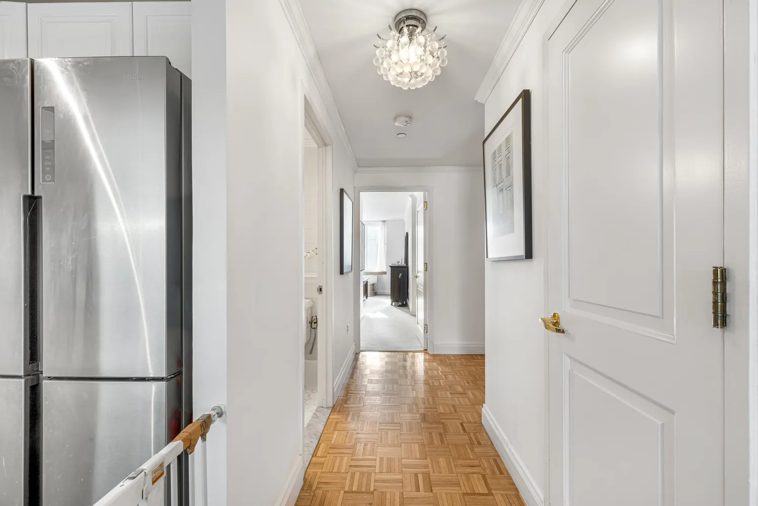 a view of a hallway with wooden floor and staircase