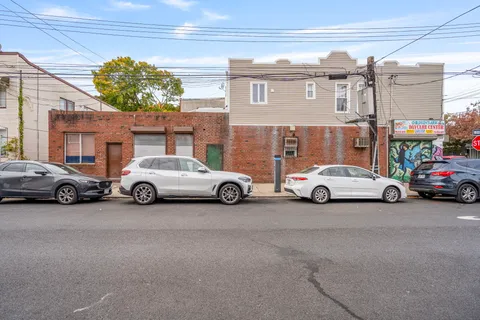 an aerial view of a building with cars parked