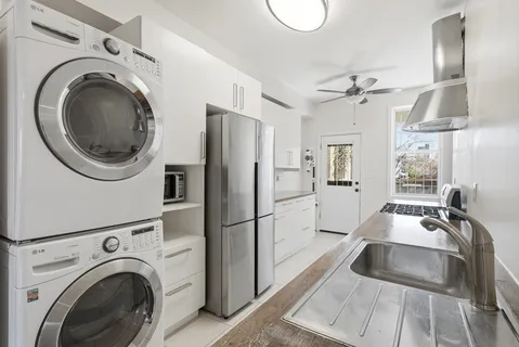 a kitchen with stainless steel appliances granite countertop a refrigerator sink and stove