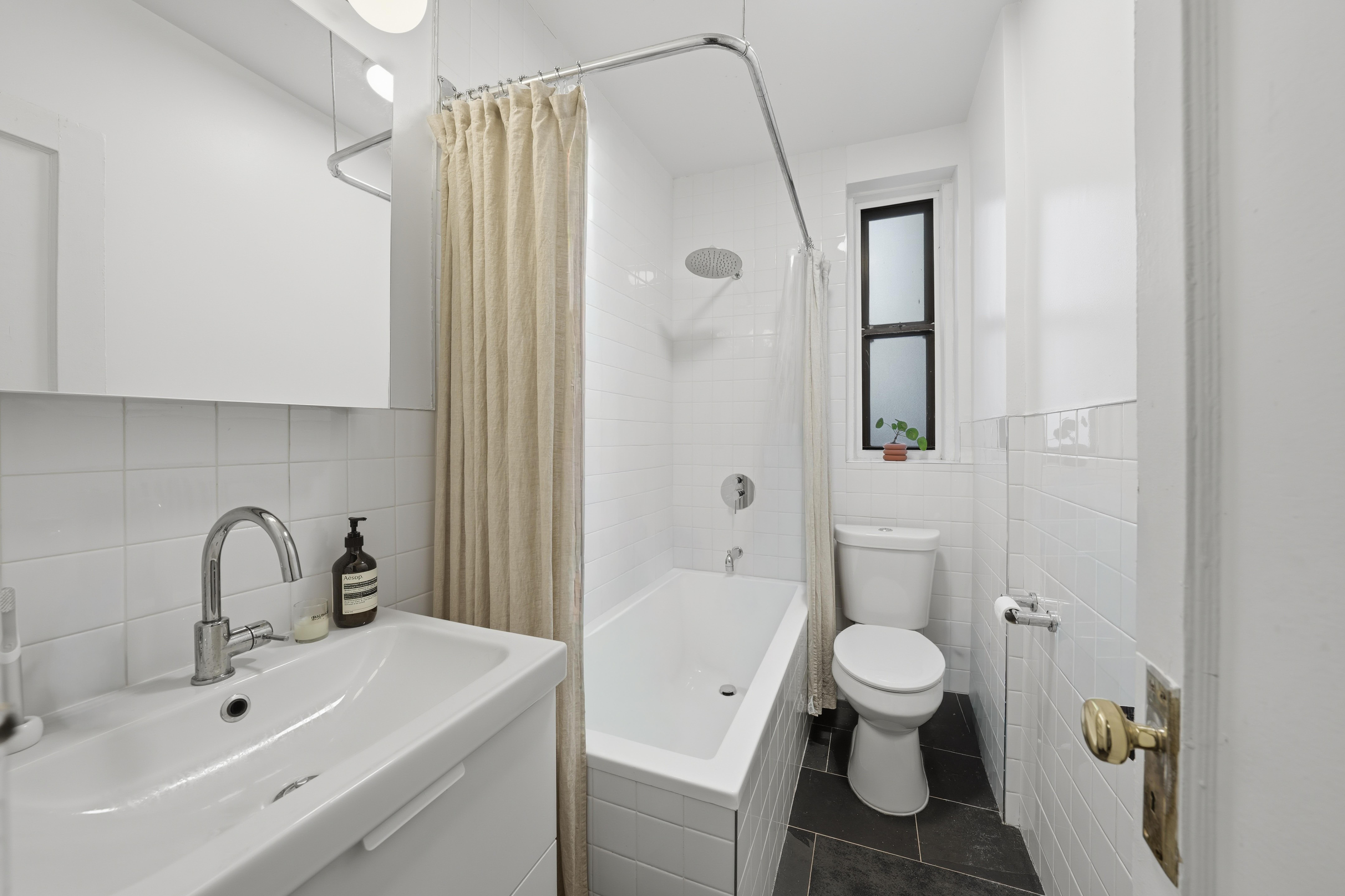 80 Avenue P, Unit D14 Brooklyn, NY 11204 - Photo 12 of 19 a bathroom with a sink toilet and shower