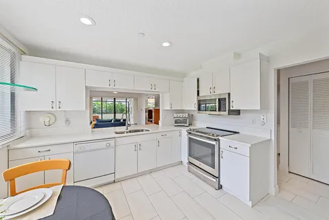 a kitchen with stainless steel appliances granite countertop a sink and cabinets