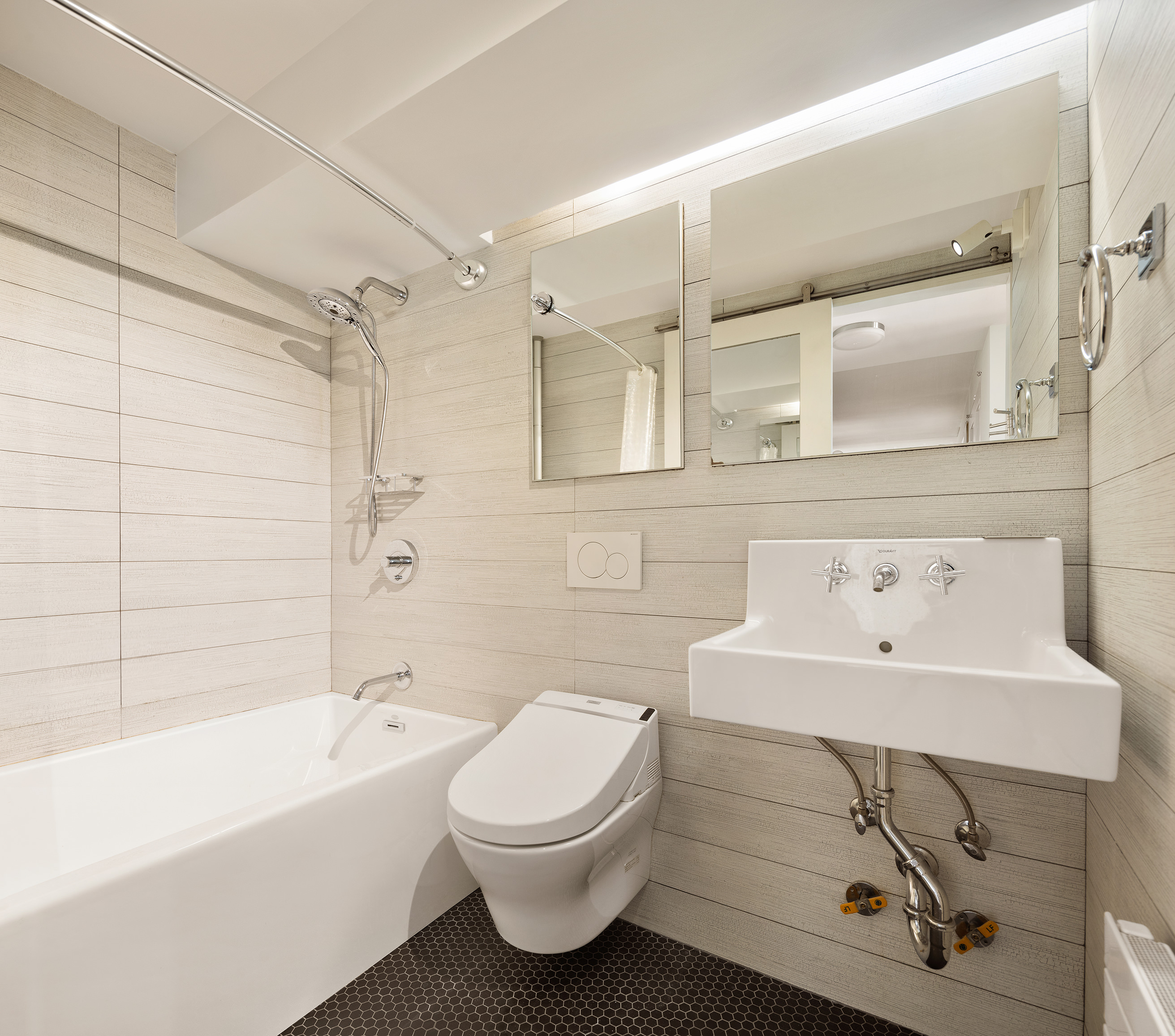 1065 Park Avenue, Unit 10CD Manhattan, NY 10128 - Photo 9 of 10 a bathroom with a sink a toilet and shower