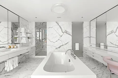 a living room with furniture and a book shelf