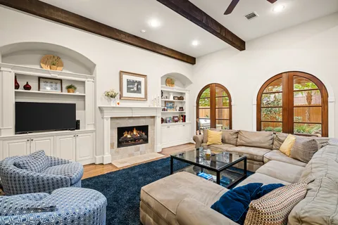 a living room with furniture a flat screen tv and a fireplace