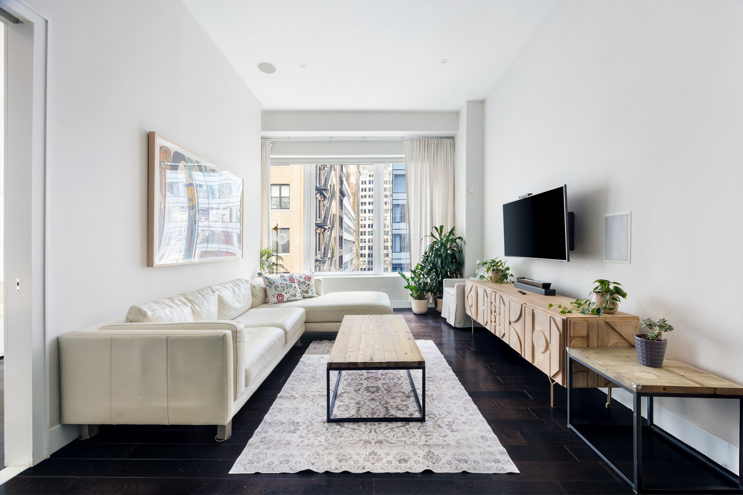 111 Fulton Street, Unit 824 Manhattan, NY 10038 - Photo 2 of 35 a living room with furniture and a flat screen tv